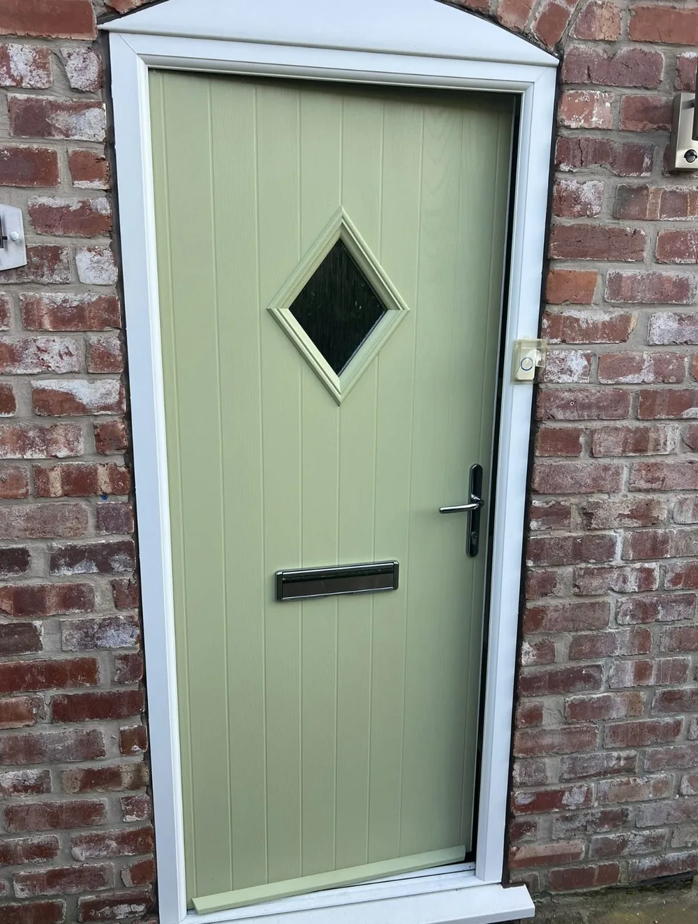 Composite front door resprayed in sage green