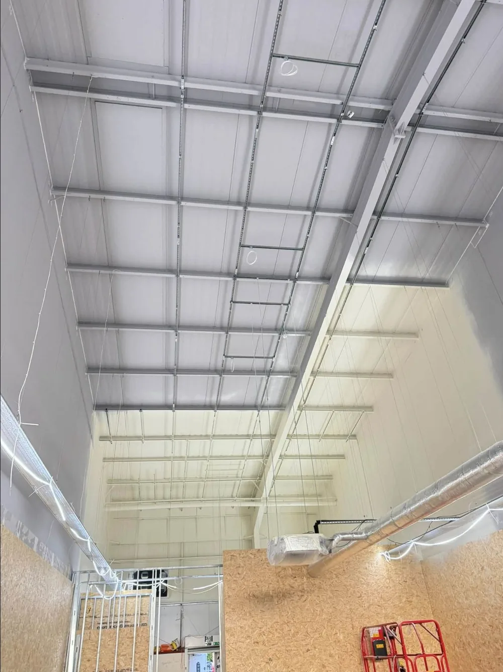 Warehouse ceiling deck and steelwork sprayed white